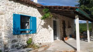 a blue window on the side of a stone house at Old Lato's House in Danilovgrad