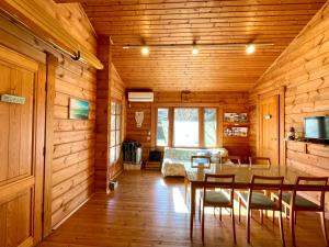 a dining room with a table and a bedroom at Sunny Side Cottage in Shimoda