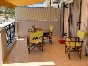 a balcony with a table and chairs on it at Cosy Apartment by the water, Agia Pelagia in Agia Pelagia