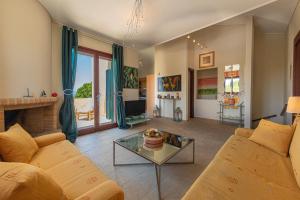 a living room with a couch and a table at Secret Garden Residence in Khlóï