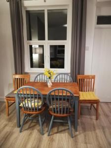 a dining room table and chairs with a window at Glenhill - Newly renovated in a unique location in Belmullet