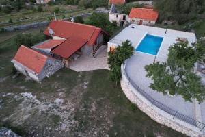 an aerial view of a house with a swimming pool at Patakun holiday home for 5, with heated pool in Lećevica