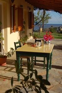 a table with flowers on it in front of a house at Panorama Apartments updated with infinity pool in Agios Nikolaos