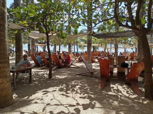 a group of people sitting in chairs on the beach at Gray House Domenico in Potrero
