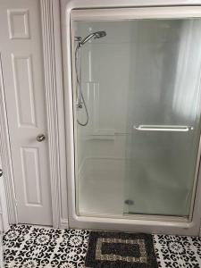 a shower with a glass door in a bathroom at Loft apartment in Kensington in Kensington +23 photos