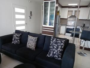 a blue couch in a living room with a kitchen at Mendoza is life in Guaymallen +25 photos