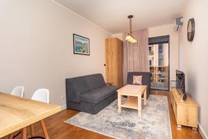 a living room with a couch and a table at Soho city apartment in Bar