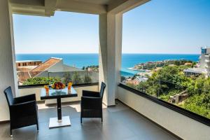 a dining room with a view of the ocean at Golden Apartments in Ulcinj