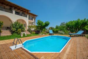 einen Pool auf einer Terrasse mit einem Haus in der Unterkunft Family Private Homes & Sea View in Lithakia