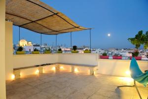 a patio with lights and a view of a city at Apartment Attico panoramico di Martina Franca in Martina Franca