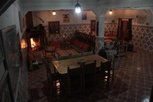 a living room with a table and a fireplace at Gîte Imarin in Agouti