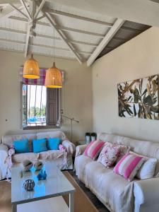 a living room with two couches and a table at Καλοκαιρινό σπίτι στο Σίγρι in Sígrion