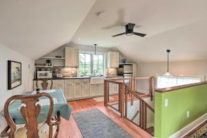 a kitchen with a table and a ceiling fan at Barn-Like Studio Suite with Flowering Garden! 