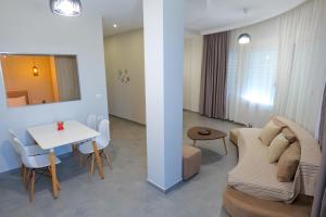 ein Wohnzimmer mit einem Sofa und einem Tisch in der Unterkunft IDEAL HOUSE & APARTMENTS in Ksamil