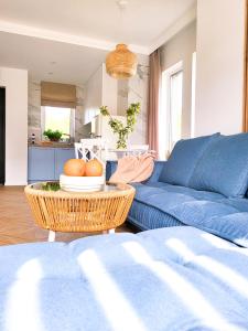 a living room with a blue couch and a table at Błękitna Dębki in Dębki