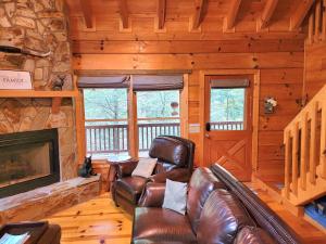 a living room with a couch and a fireplace at LUXURY CABIN WITH WATERVIEW AND PRIVACY, hiking in Blue Ridge