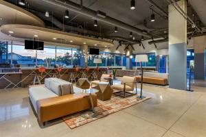 a lobby with couches and chairs and a bar at Vīb Hotel by Best Western Phoenix - Tempe in Tempe
