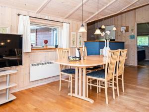 a kitchen and dining room with a table and chairs at 4 star holiday home in Hemmet in Hemmet