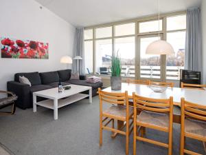 a living room with a couch and a table at Apartment for 6 guests with loft, Ringkøbing in Ringkøbing