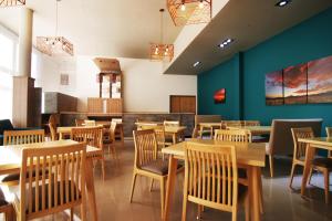 a dining room with wooden tables and chairs at Hotel Terra Patagonia in Malargüe