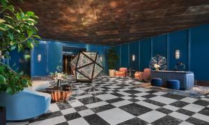 a lobby with blue walls and a checkered floor at Pendry West Hollywood in Los Angeles