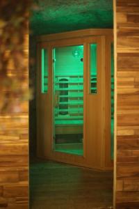a window in a house with green lights at La Montrieuse, Chambre individuelle avec sauna et baignoire spa in Naveil