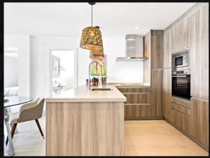 a kitchen with a island with a pendant light at Puerto Banus luxury apartment located in harbor in Marbella