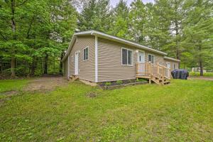 a small house in the middle of a yard at Vacation Rental In-Between Houghton and Higgins Lake in Houghton Lake