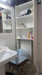 a bathroom with a basket next to a sink at 1er etage privatif dans une maison in La Colle-sur-Loup