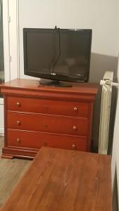 a television sitting on top of a dresser at 1er etage privatif dans une maison in La Colle-sur-Loup