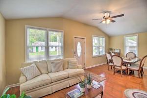 a living room with a couch and a table at Updated Savannah Hideaway with Luxury Backyard! in Savannah