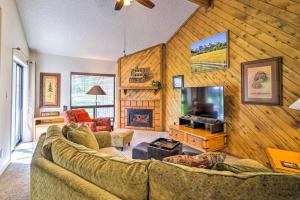 a living room with a large couch and a tv at Cozy Pagosa Springs Retreat Fire Pit and Patio in Pagosa Springs