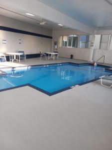 a large pool with blue water in a building at Motel 6 Dawsonville GA North GA Premium Outlets in Dawsonville