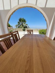 a table with chairs and a view of the beach at VILLA SERAPHO in Paphos