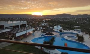 a view of a resort with a swimming pool at ERNESTINA VILLAGE Resort Apart & suites in Villa Carlos Paz +37 photos