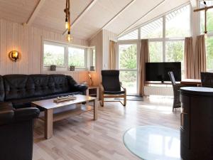 a living room with a couch and a coffee table at 6 person holiday home in GROEMITZ in Grömitz