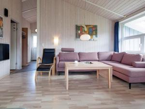 a living room with a couch and a table at Three-Bedroom Holiday home in Grömitz 6 in Grömitz