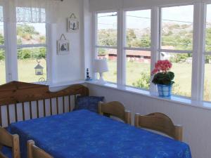 a dining room with a blue table and windows at Two-Bedroom Holiday home in Kärna 1 in Lycke