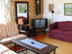 a living room with two couches and a tv at Two-Bedroom Holiday home in Kärna 1 in Lycke