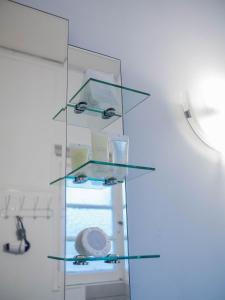 a glass shelf in a room with a sink at New York Suites in Viña del Mar