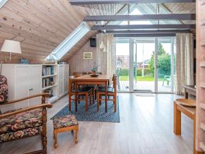 a dining room with a table and a couch at 6 person holiday home in Hejls in Hejls