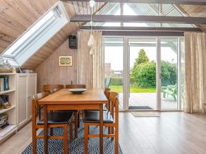 HejlsにあるTwo-Bedroom Holiday home in Hejls 10のダイニングルーム(木製テーブル、椅子付)