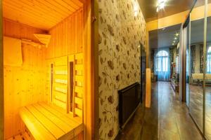 a wooden room with a bench and a wall at Akacfaapartman in Budapest
