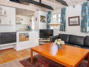 a living room with a couch and a coffee table at 6 person holiday home in Hvide Sande in Nørre Lyngvig