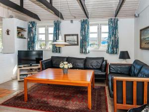 a living room with a couch and a coffee table at 6 person holiday home in Hvide Sande in Nørre Lyngvig