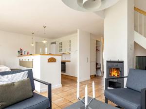 a living room with a couch and a fireplace at 8 person holiday home in Brenderup Fyn-By Traum in Bro