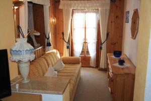 ein Wohnzimmer mit einer Couch und einem Fenster in der Unterkunft Alpenpension Auengrund in Ramsau bei Berchtesgaden