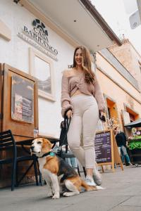 a pregnant woman is standing next to a dog at Hotel Casa del Barranco in Cuenca