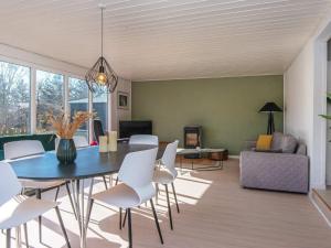 a living room with a blue table and white chairs at 6 person holiday home in Løgstør-By Traum in Løgsted +35 photos