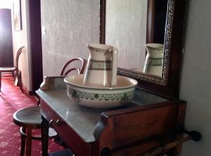 a bowl on a dresser in front of a mirror at Hotel Croix d'Or et Poste - Historisches Hotel in Münster